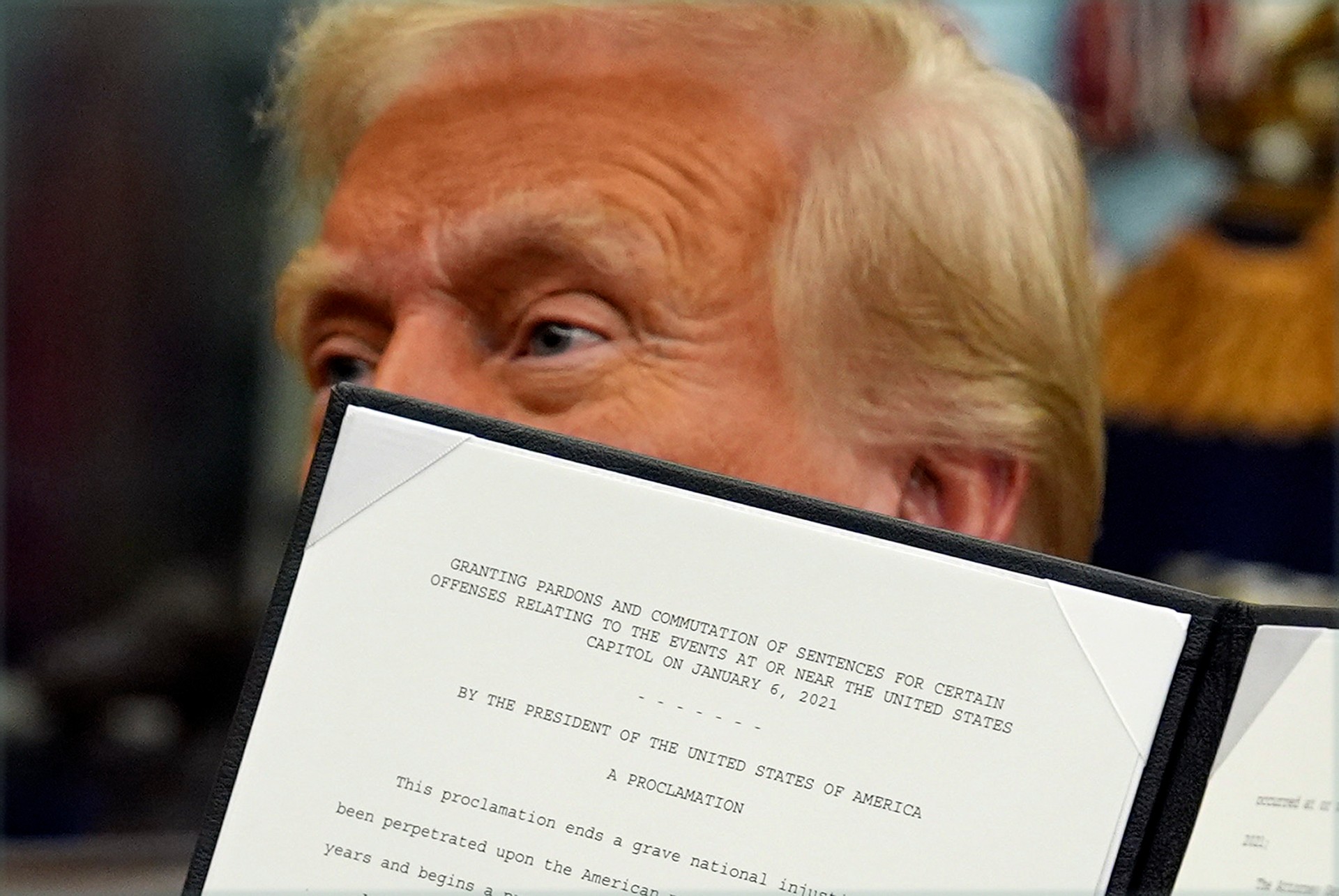 President Donald Trump signs an executive order pardoning about 1,500 defendants charged in the Jan. 6 attack on the U.S. Capitol in the Oval Office of the White House, Monday, Jan. 20, 2025, in Washington. (AP Photo/Evan Vucci)