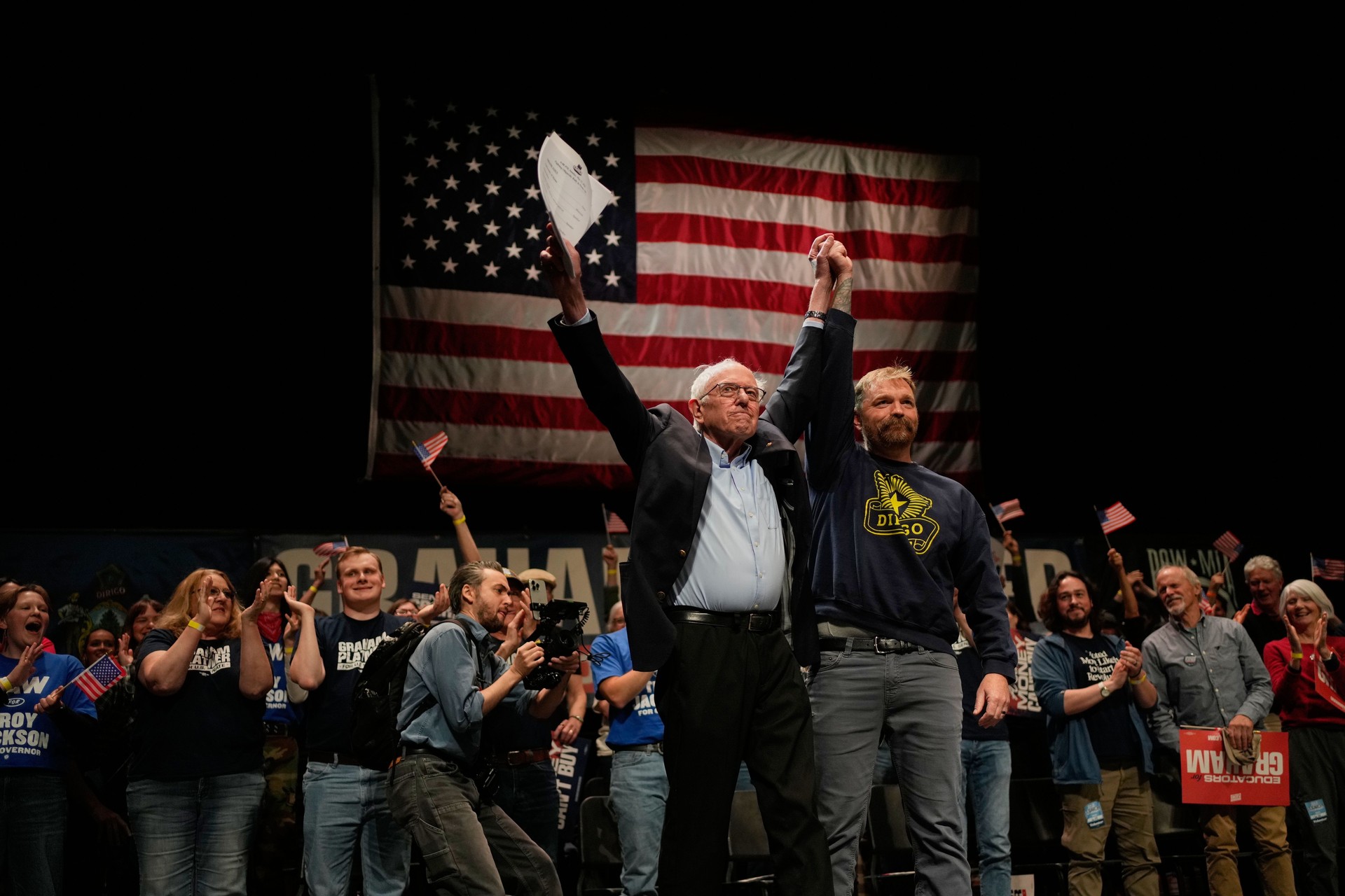 Graham Platner, Democratic candidate for U.S. Senate, and Sen. Bernie Sanders, left, join hands at an event in Orono, Maine, Sunday, May 24, 2026. (AP Photo/Robert F. Bukaty)