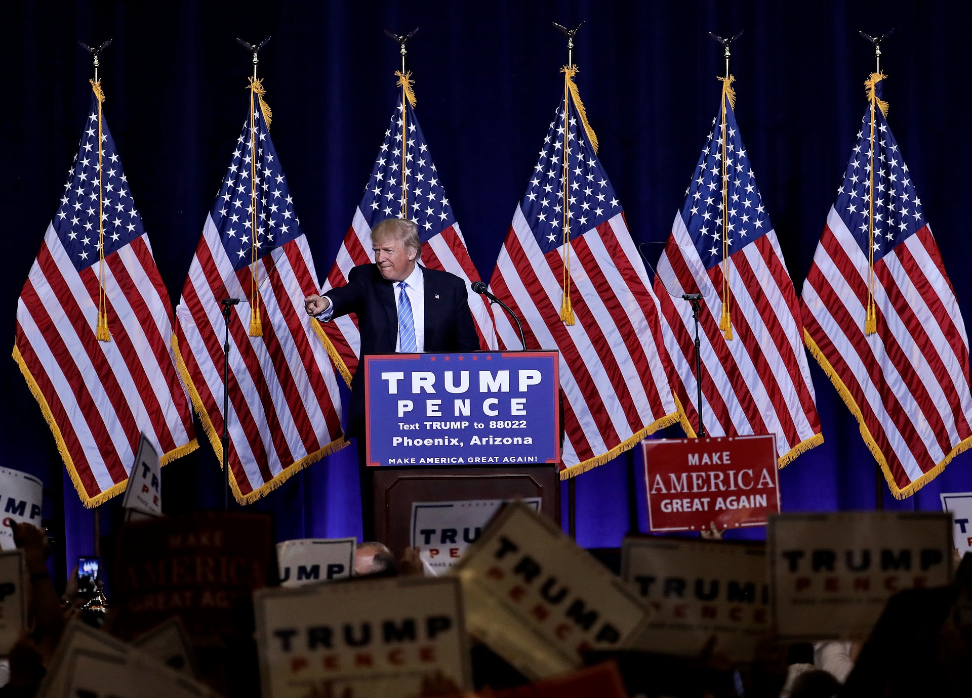 Republican presidential candidate Donald Trump points to the audience after delivering an immigration policy speech during a campaign rally at the Phoenix Convention Center, Wednesday, Aug. 31, 2016, in Phoenix. (AP Photo/Matt York)